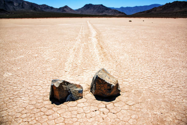 Moving Rocks of the Racetrack Playa The famed and mysterious moving rocks along the dry lake bed of Death Valley's Racetrack Playa leaving their tracks behind. racetrack playa stock pictures, royalty-free photos & images