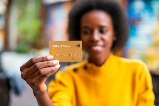 istock Woman holding a credit card 1202858313