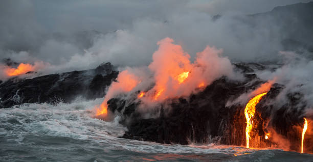 istock Molten lava flowing into the ocean 1202859275