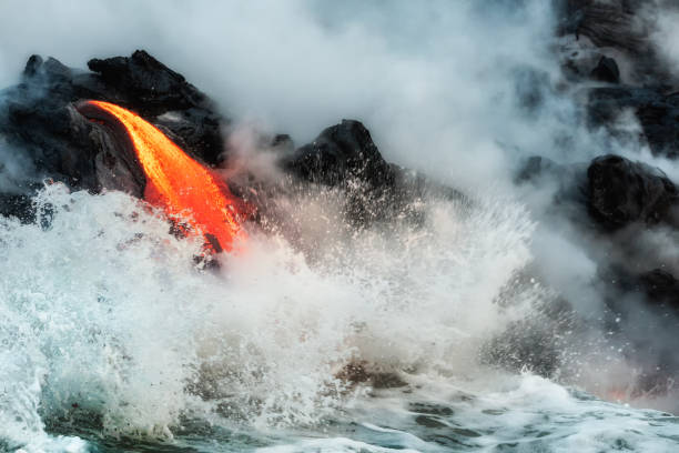 istock Molten lava flowing into the ocean 1202859778