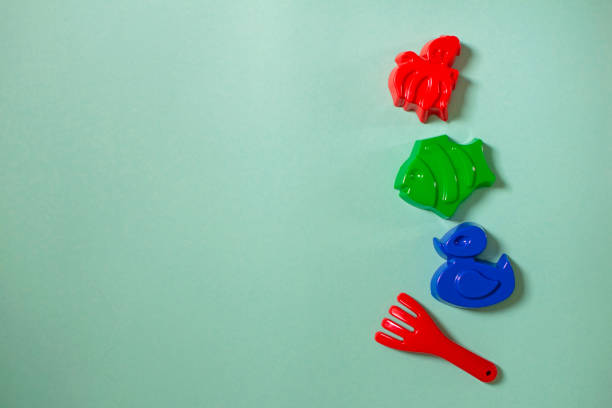Children beach toys isolated on yellow background