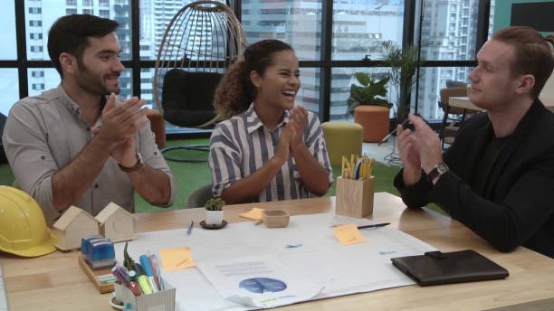 istock Creative business people group having conversation at office desk in workplace. 1202870182