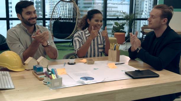 istock Creative business people group having conversation at office desk in workplace. 1202870184