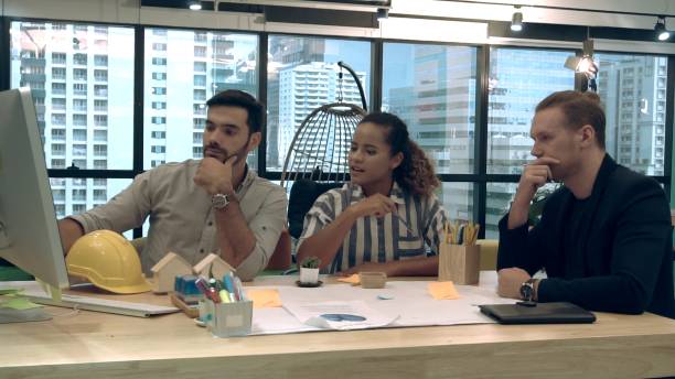 istock Creative business people group having conversation at office desk in workplace. 1202870198
