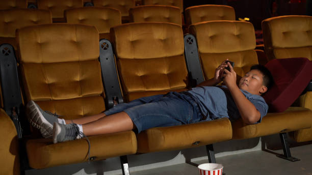 istock A boy laying down and playing mobile phone 1202870579
