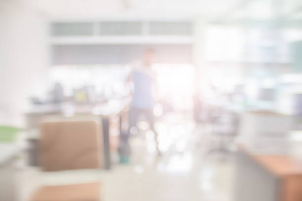istock Businessman blur in the workplace at sitting on a computer screen work space on table desk work in office blurry, document division and people shallow depth of focus horizontal abstract interior. 1202871648