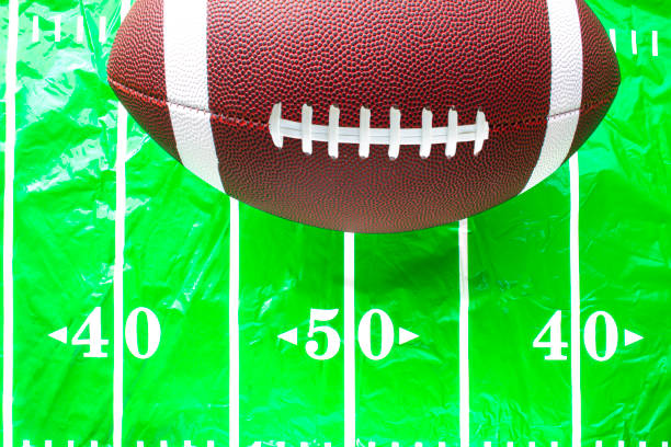 football on a plastic fitted american football field table cover - american football football food snack imagens e fotografias de stock