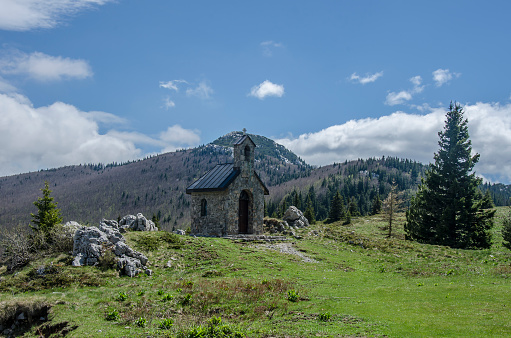 Stone chapel and mountain road in Velebit mountains, Northern Velebit National Park, Croatia