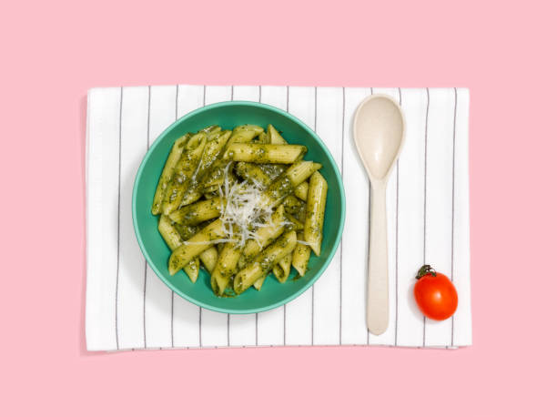 istock Penne pasta with pesto sauce on white cloth. 1202880851