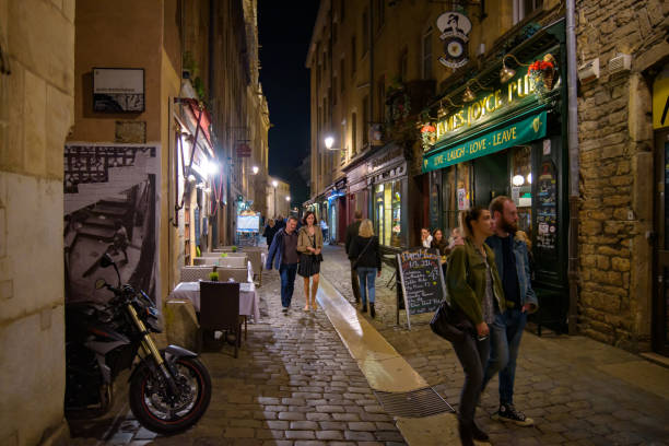 People walking on the street of the Old Town at night in Lyon, France stock photo