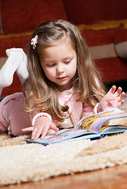 istock sweet little girl reading book 120288790