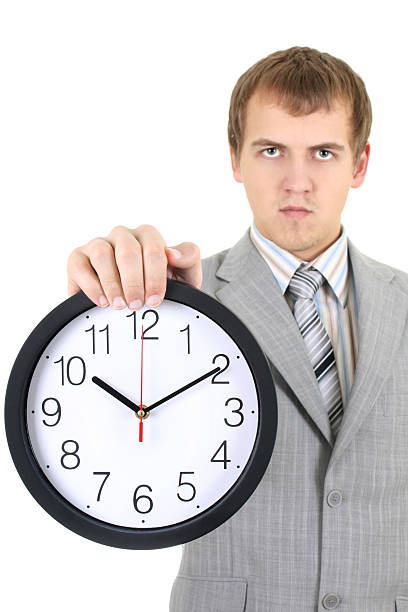 istock young businessman holding a clock 120288833