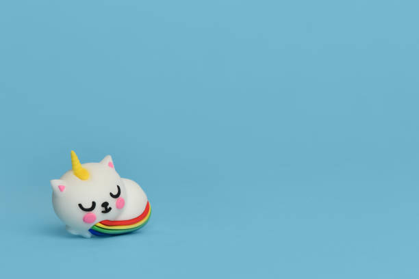 istock Cat unicorn with rainbow tail isolated on a blue background. 1202890180