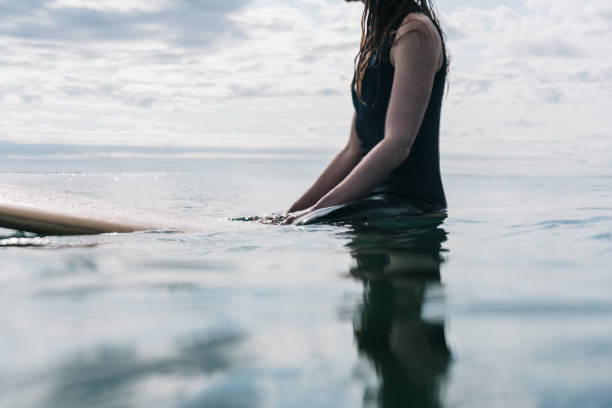 istock Surfer woman on wooden longboard 1202890704
