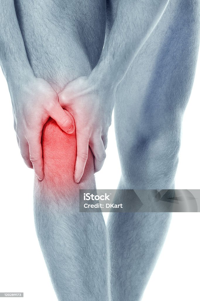 Pain in a knee. sports trauma young sportsman has clasped hands a sick knee to reduce a pain. public health services concept Cartilage Stock Photo