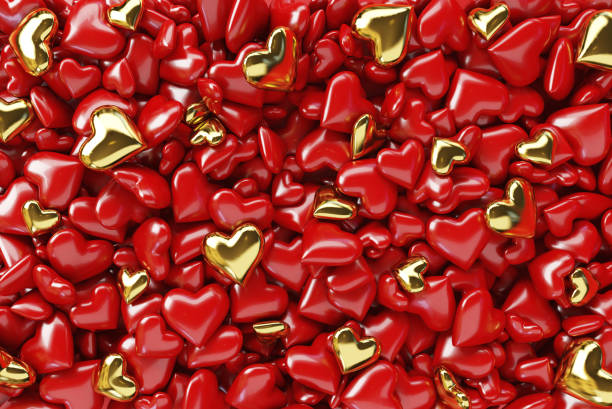 istock Many small red and gold hearts background. 1202891813