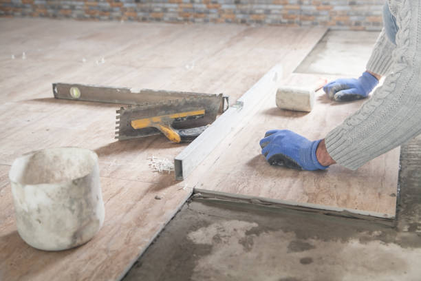 istock Laying floor ceramic tile. Renovating the floor 1202893740