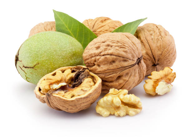 istock Ripe walnut and leaves isolated on a white background 1202896306
