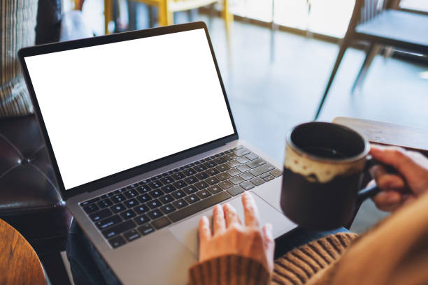 istock a woman using and touching on laptop touchpad with blank white desktop screen while drinking coffee 1202896763