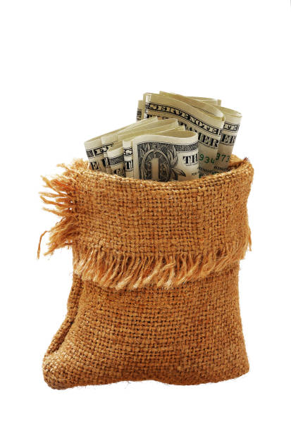 istock burlap sack filled with folded dollar banknotes isolated on white background 1202898276