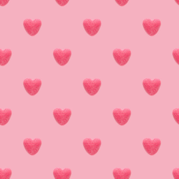 istock Seamless pattern with red marmalade hearts on a pink background 1202899010