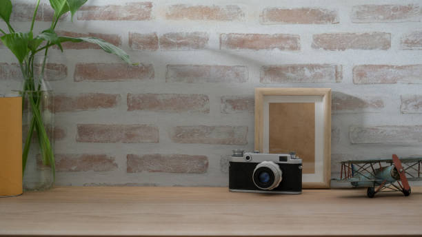 istock Close up view of photographer workspace with camera mock up frame and decorations 1202900200