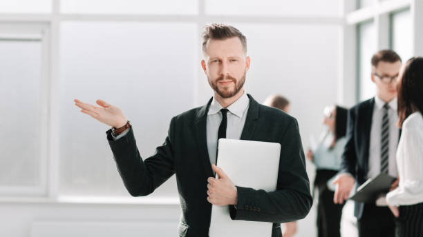 istock businessman with a laptop holds a virtual object in his hand. 1202901716