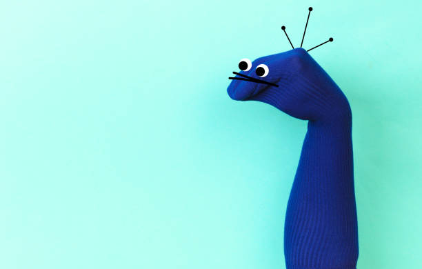 funny doll sock on blue background, hand theater