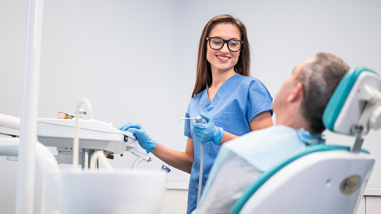 Mid adult man having teeth examined at dentists