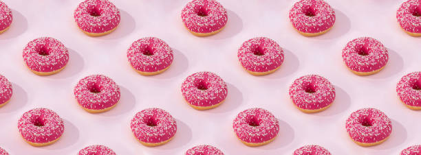 istock Pattern of Pink donuts with icing on pink background, flat lay 1202905723