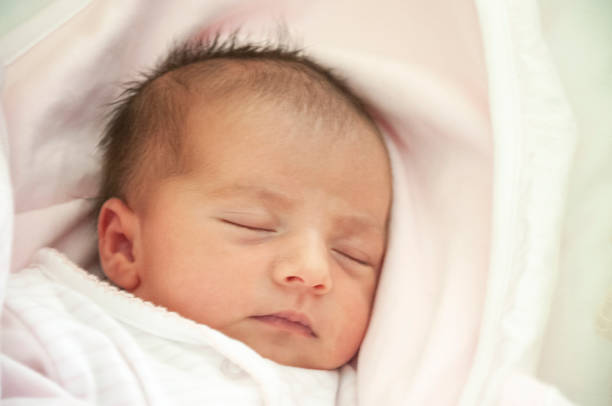 istock Newborn baby sleeping five days after birth 1202906637