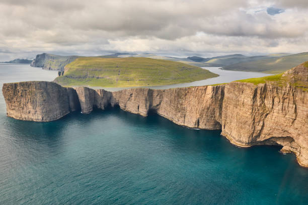 Faroe islands dramatic coastline in Vagar. Leitisvatn lake Faroe islands dramatic coastline in Vagar from helicopter. Leitisvatn lake vágar photos stock pictures, royalty-free photos & images