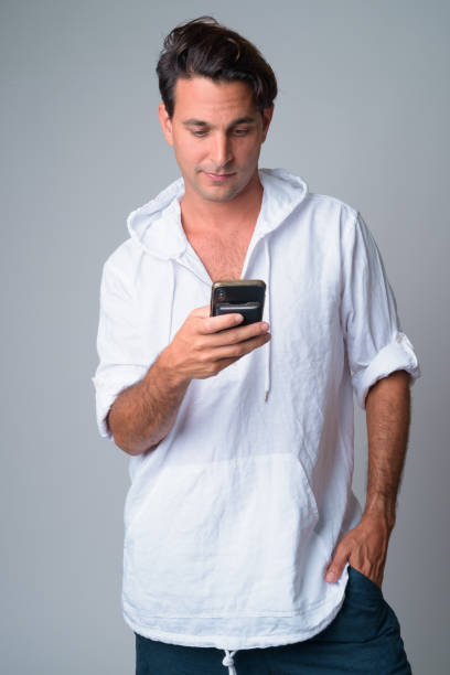 istock Portrait of handsome Hispanic man using phone 1202907213