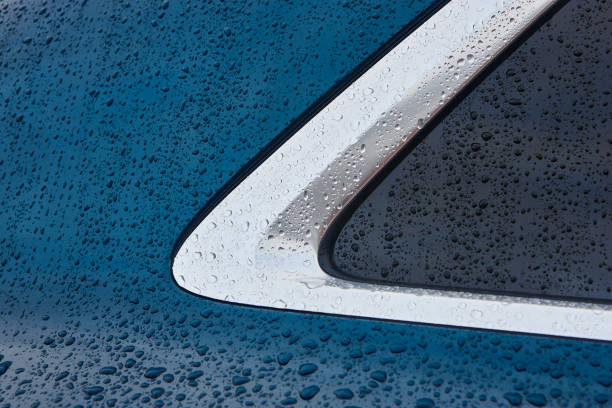 istock Rain drops on a car window metallic surface. Automobile detail 1202907277