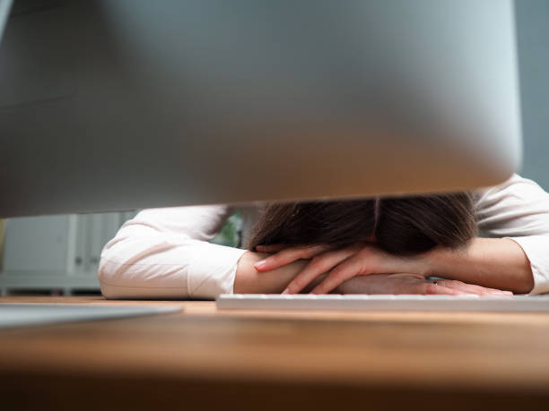 istock Tired female employee at office workplace taking nap 1202907434