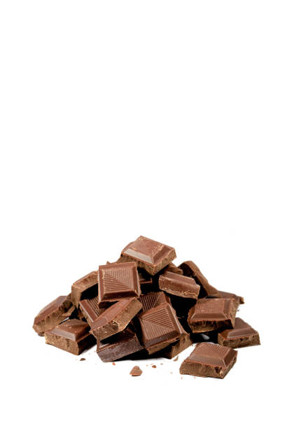 istock Vertical Image of Pile of Chocolate Chunks Isolated on White Background with Copy Space 1202909472