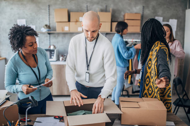 istock Diverse group of people arranging customers orders for drop shipping 1202909547