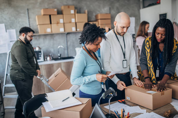 istock Diverse group of people arranging customers orders for drop shipping 1202909646