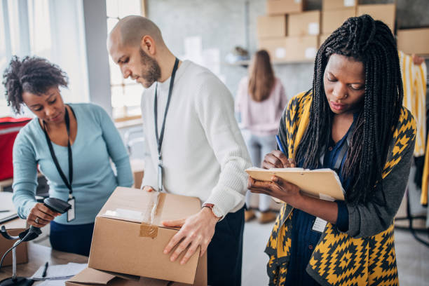 istock Diverse group of people arranging customers orders for drop shipping 1202909806