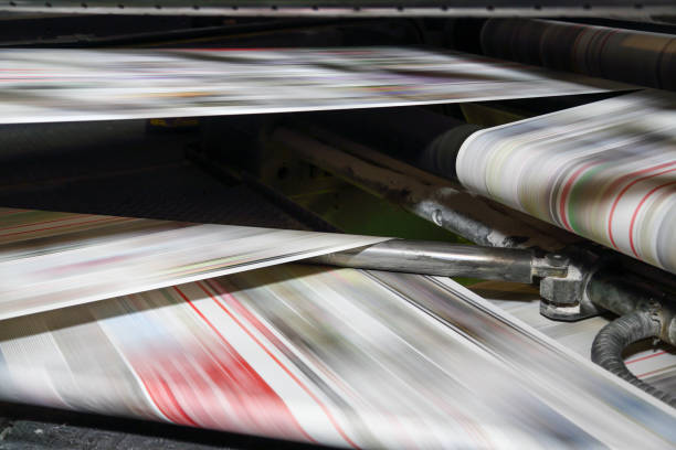 istock Newspaper folding machine in a printing plant 1202910408