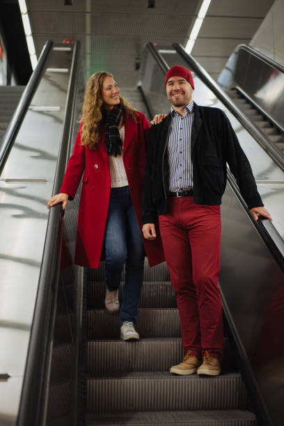 istock Smiling couple on the escalator 1202911414