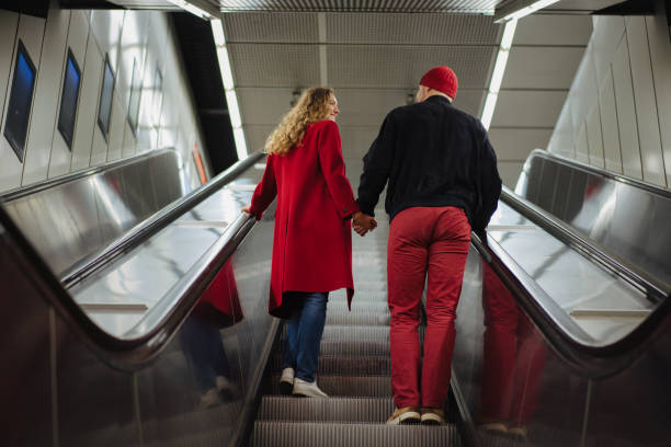 istock Smiling couple on the escalator 1202911724