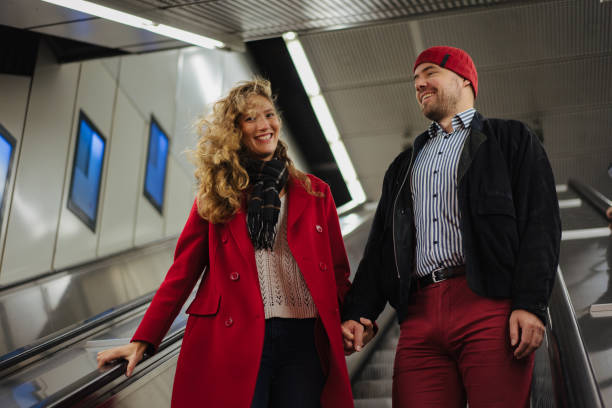 istock Smiling couple on the escalator 1202911812