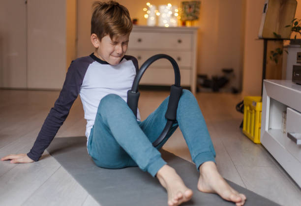 istock Little boy making an effort while exercising at home. 1202911960