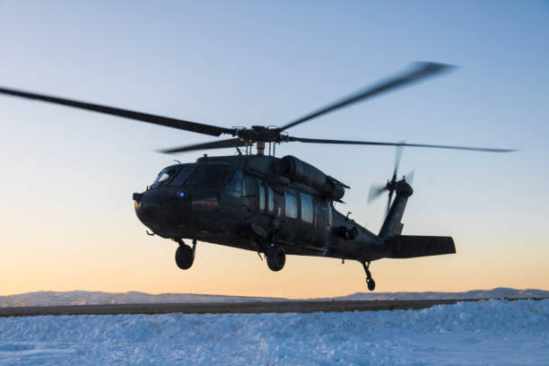 istock Black Hawk helicopter hovering above snowy ground 1202912707