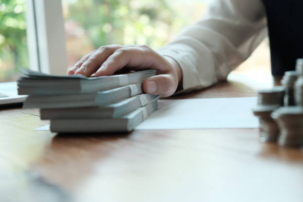 istock Businessman analyzing investment charts and pressing calculator buttons over documents. Accounting Concept  Saving Economy concept. 1202913018