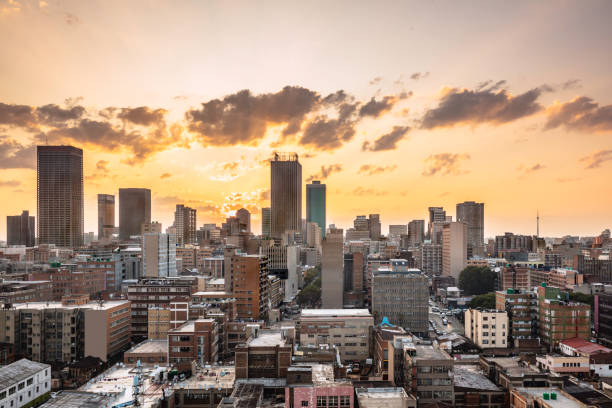 Johannesburg city centre cityscape panorama at sunset Johannesburg cityscape panorama at sunset retro, Johannesburg is also known as Jozi, Jo'burg or eGoli, is the largest city in South Africa. It is the provincial capital of Gauteng, the wealthiest province in South Africa, having the largest economy of any metropolitan region in Sub-Saharan Africa. johannesburg stock pictures, royalty-free photos & images