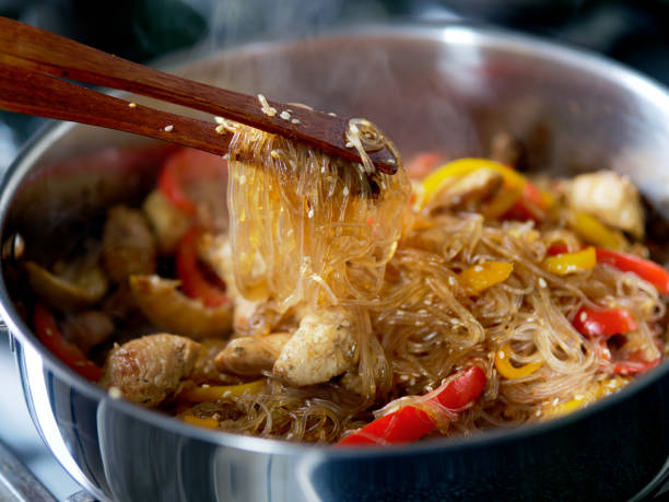 Cooking fried cellophane noodles and chicken in soy sauce