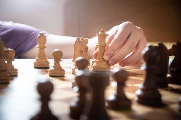 istock Close up of hand playing chess game 1202917461