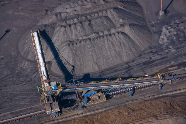 istock Unloading coal from an open storage warehouse using a reclaimer and conveyor equipment. As well as loading with a stacker 1202918822